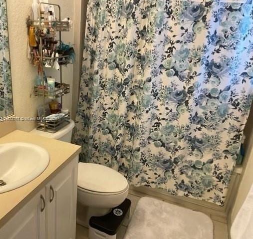 4812 Washington St Unit 8, Hollywood, FL 33021 - full bath featuring vanity, curtained shower, and tile patterned flooring