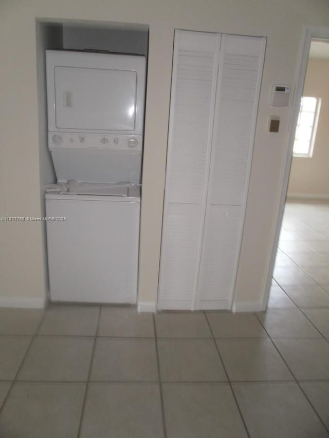 4812 Washington St Unit 8, Hollywood, FL 33021 - washroom featuring stacked washer and clothes dryer and light tile patterned floors