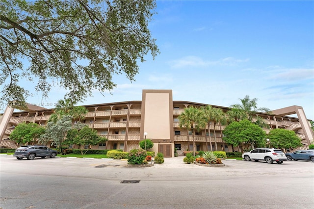 1704 Andros Isle Unit C2, Coconut Creek, FL 33066 - view of building exterior with uncovered parking
