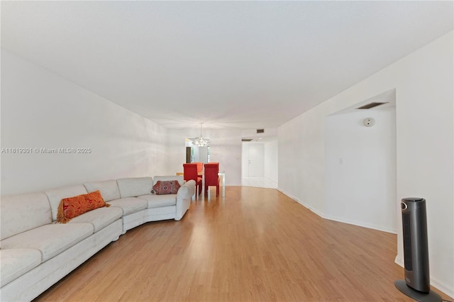 1704 Andros Isle Unit C2, Coconut Creek, FL 33066 - living room featuring light wood finished floors and a chandelier