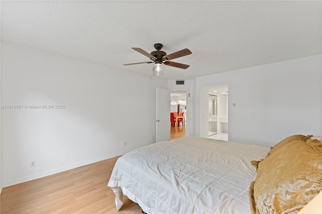 1704 Andros Isle Unit C2, Coconut Creek, FL 33066 - bedroom featuring light wood-style floors, ensuite bath, and ceiling fan