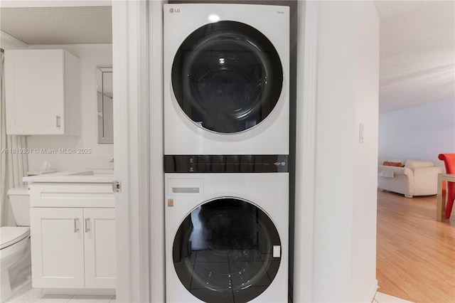 1704 Andros Isle Unit C2, Coconut Creek, FL 33066 - washroom featuring stacked washer / dryer and a sink