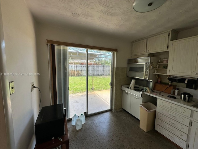 3180 NE 10th Ter, Pompano Beach, FL 33064 - kitchen with light countertops and white cabinetry
