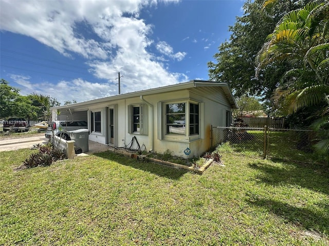 3180 NE 10th Ter, Pompano Beach, FL 33064 - view of front of house with stucco siding, a carport, and driveway