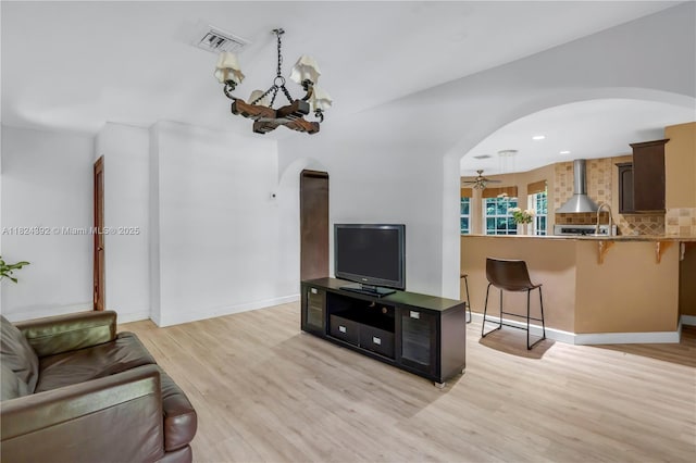 10901 SW 31st St, Davie, FL 33328 - living area featuring arched walkways, light wood-style flooring, a chandelier, and ceiling fan