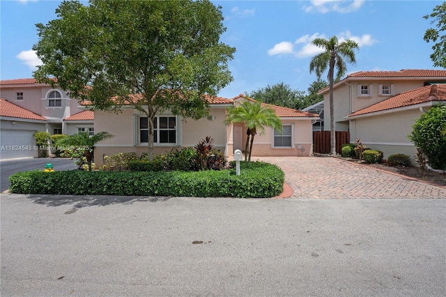 4731 NW 7th Mnr, Coconut Creek, FL 33063 - mediterranean / spanish home featuring a tile roof, stucco siding, and decorative driveway