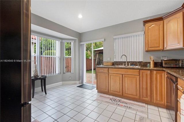 4731 NW 7th Mnr, Coconut Creek, FL 33063 - kitchen with appliances with stainless steel finishes, dark stone countertops, light tile patterned floors, and recessed lighting