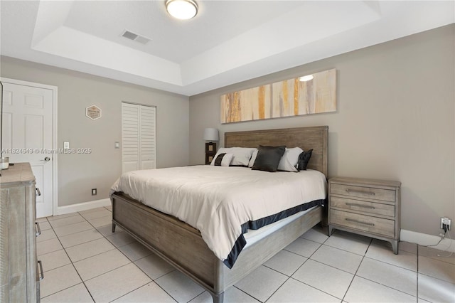 4731 NW 7th Mnr, Coconut Creek, FL 33063 - bedroom featuring a tray ceiling, light tile patterned floors, and a closet