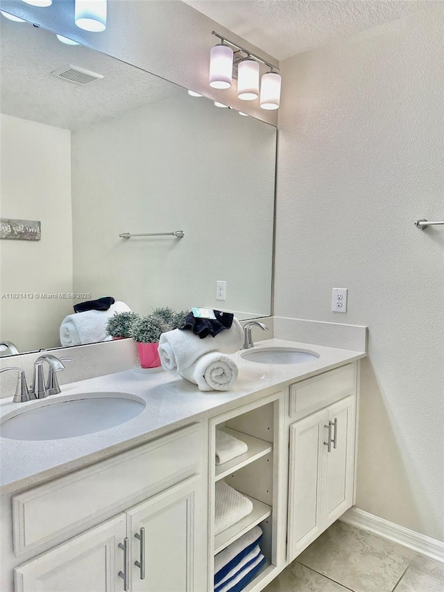 4751 Clock Tower Dr Unit 307, Kissimmee, FL 34746 - bathroom with double vanity and a textured ceiling