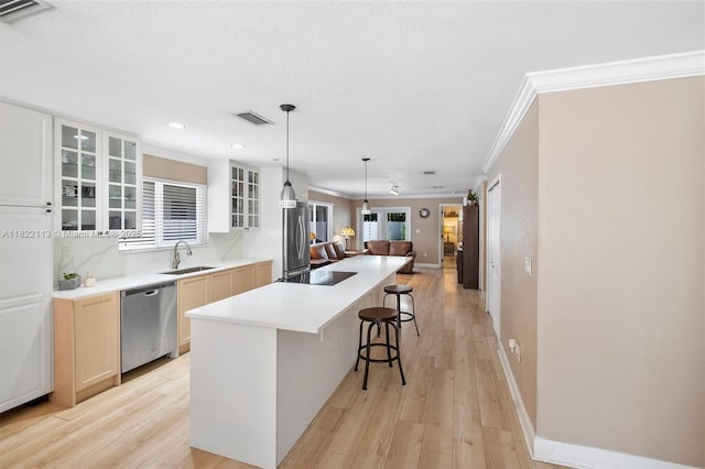 2309 SW 62nd Ct, Miami, FL 33155 - kitchen featuring stainless steel dishwasher, a kitchen breakfast bar, glass insert cabinets, light wood-style floors, and ornamental molding