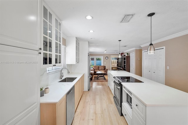 2309 SW 62nd Ct, Miami, FL 33155 - kitchen featuring appliances with stainless steel finishes, light wood-style flooring, glass insert cabinets, recessed lighting, and open floor plan