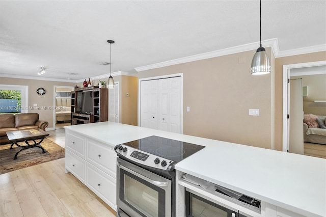 2309 SW 62nd Ct, Miami, FL 33155 - kitchen with stainless steel electric range oven, open floor plan, ornamental molding, light wood-style floors, and white cabinets