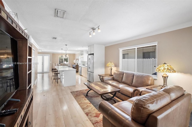 2309 SW 62nd Ct, Miami, FL 33155 - living room with crown molding, light wood finished floors, and a textured ceiling