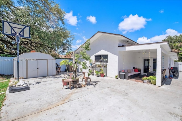 2309 SW 62nd Ct, Miami, FL 33155 - back of property featuring an outdoor living space, a storage unit, a patio area, and stucco siding