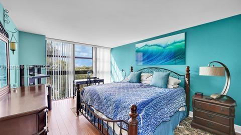 200 Leslie Dr Unit 407, Hallandale Beach, FL 33009 - bedroom featuring wood finished floors and floor to ceiling windows
