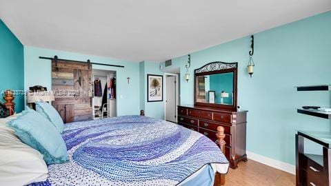 200 Leslie Dr Unit 407, Hallandale Beach, FL 33009 - bedroom with a barn door and wood finished floors