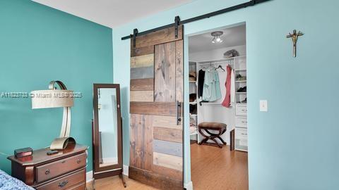 200 Leslie Dr Unit 407, Hallandale Beach, FL 33009 - bedroom with wood finished floors, a barn door, and a closet