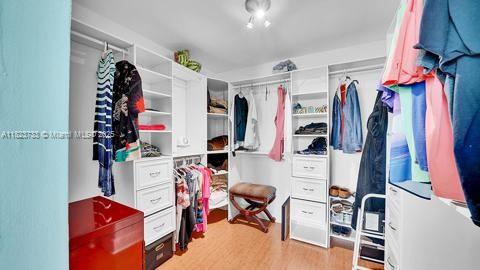 200 Leslie Dr Unit 407, Hallandale Beach, FL 33009 - spacious closet featuring light wood-style floors