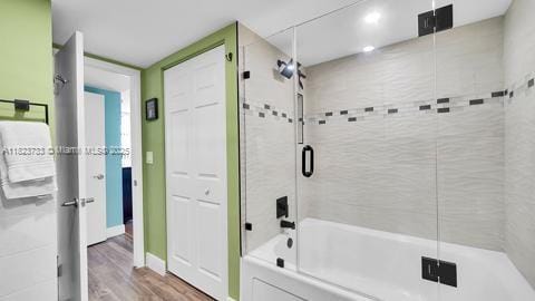200 Leslie Dr Unit 407, Hallandale Beach, FL 33009 - full bathroom featuring wood finished floors and combined bath / shower with glass door