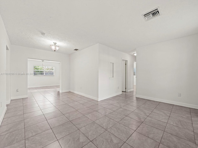 15314 SW 102nd Ct, Miami, FL 33157 - empty room featuring tile patterned flooring and a textured ceiling