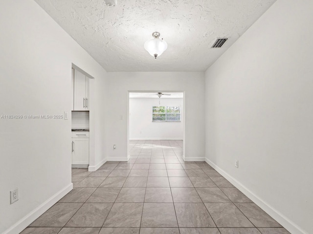 15314 SW 102nd Ct, Miami, FL 33157 - spare room with a textured ceiling, light tile patterned floors, and ceiling fan