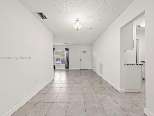 15314 SW 102nd Ct, Miami, FL 33157 - spare room with a textured ceiling and light tile patterned floors