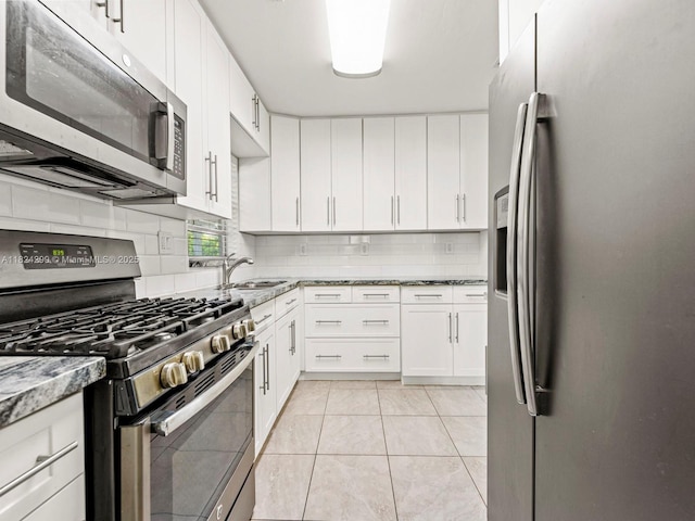 15314 SW 102nd Ct, Miami, FL 33157 - kitchen with stainless steel appliances, backsplash, white cabinetry, and light stone countertops