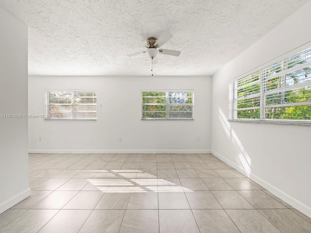 15314 SW 102nd Ct, Miami, FL 33157 - spare room with plenty of natural light, a ceiling fan, light tile patterned flooring, and a textured ceiling