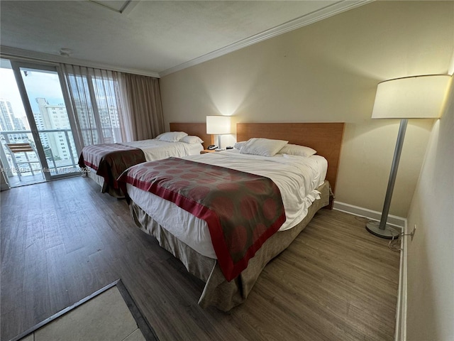 19201 Collins Ave Unit 1137, Sunny Isles Beach, FL 33160 - bedroom featuring access to exterior, crown molding, wood finished floors, and a city view