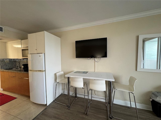 19201 Collins Ave Unit 1137, Sunny Isles Beach, FL 33160 - dining room with ornamental molding and light wood-style flooring