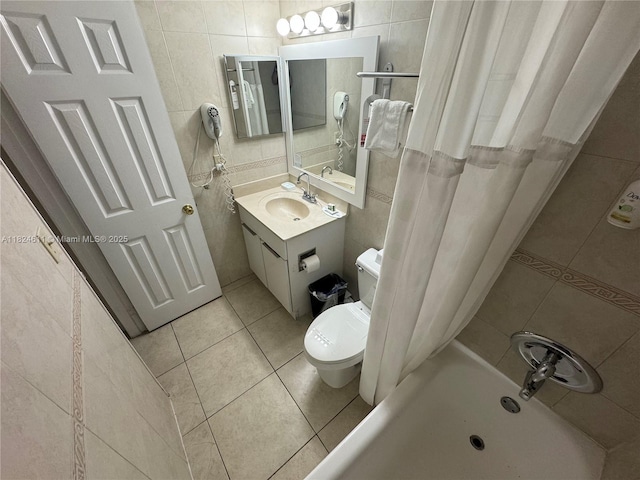 19201 Collins Ave Unit 1137, Sunny Isles Beach, FL 33160 - bathroom with tile walls, tile patterned flooring, vanity, and shower / bathtub combination with curtain