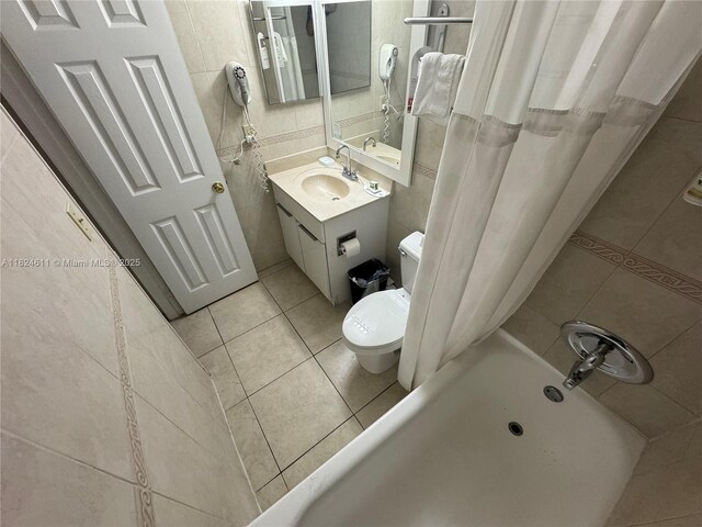 19201 Collins Ave Unit 1137, Sunny Isles Beach, FL 33160 - bathroom with tile patterned flooring, tile walls, vanity, and shower / tub combo with curtain