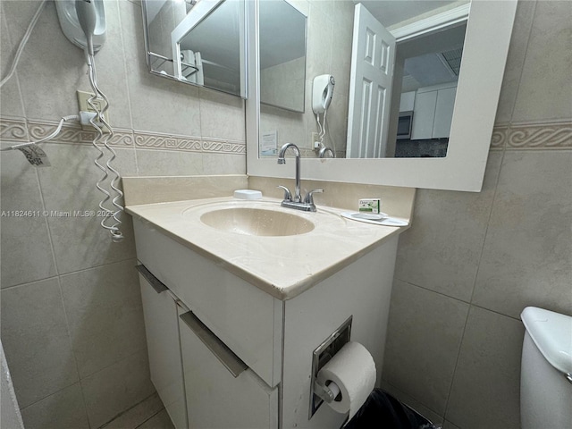 19201 Collins Ave Unit 1137, Sunny Isles Beach, FL 33160 - bathroom featuring tile walls and vanity