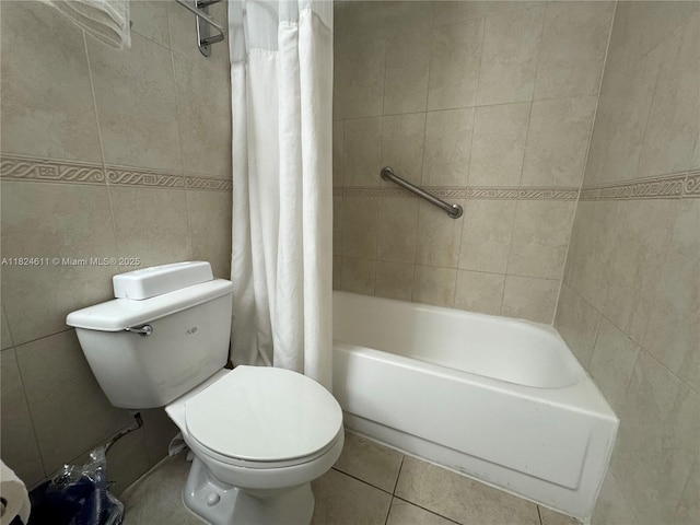 19201 Collins Ave Unit 1137, Sunny Isles Beach, FL 33160 - bathroom featuring shower / bathtub combination with curtain, tile patterned floors, and tile walls