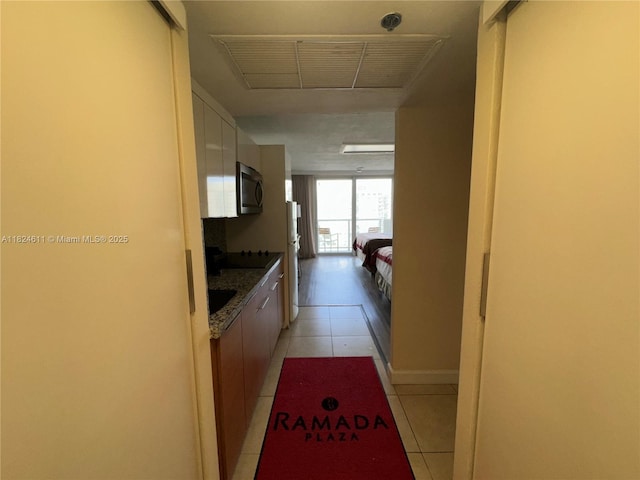 19201 Collins Ave Unit 1137, Sunny Isles Beach, FL 33160 - hallway featuring light tile patterned floors and attic access