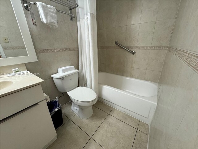 19201 Collins Ave Unit 1137, Sunny Isles Beach, FL 33160 - full bathroom featuring tile patterned floors, tile walls, shower / tub combo with curtain, and vanity