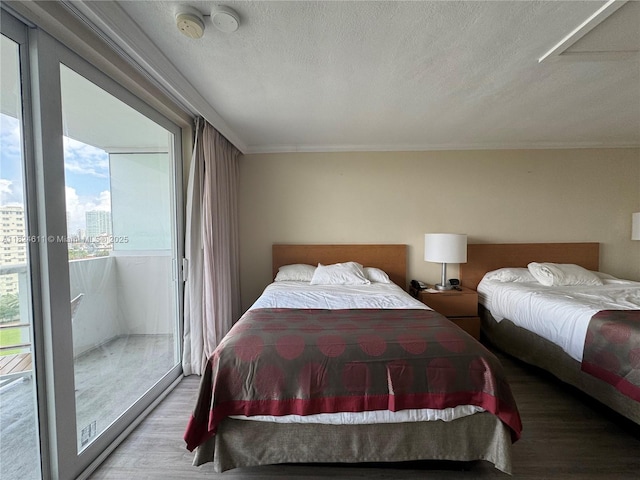 19201 Collins Ave Unit 1137, Sunny Isles Beach, FL 33160 - bedroom featuring wood finished floors, access to outside, and a textured ceiling