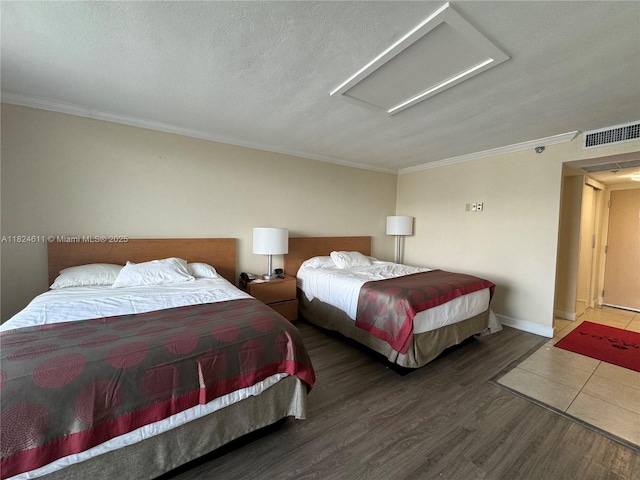 19201 Collins Ave Unit 1137, Sunny Isles Beach, FL 33160 - bedroom featuring attic access, ornamental molding, wood finished floors, and a textured ceiling