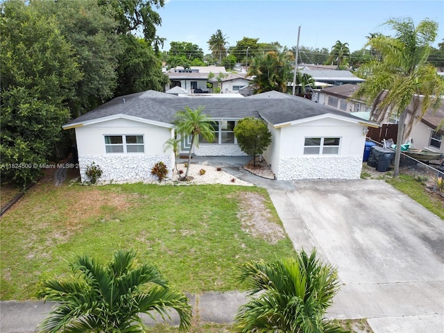 6459 Evans St, Hollywood, FL 33024 - ranch-style house with stone siding, stucco siding, a shingled roof, and driveway