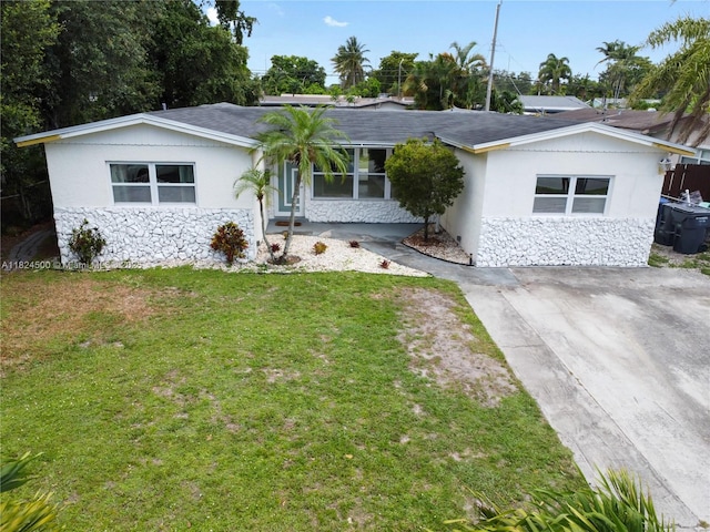 6459 Evans St, Hollywood, FL 33024 - ranch-style home featuring stone siding, a front yard, stucco siding, and roof with shingles