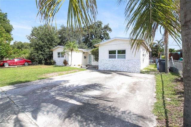 6459 Evans St, Hollywood, FL 33024 - view of front of property featuring stone siding, stucco siding, and concrete driveway