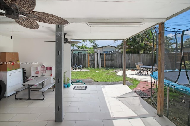 6459 Evans St, Hollywood, FL 33024 - fenced backyard with washer / clothes dryer, a trampoline, ceiling fan, and a patio