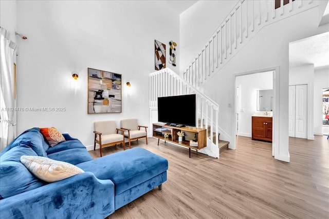 12926 SW 50th St, Miramar, FL 33027 - living area with a high ceiling, stairway, and light wood-style floors
