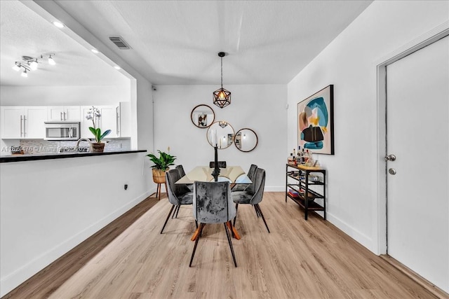 12926 SW 50th St, Miramar, FL 33027 - dining area with light wood-type flooring and a chandelier