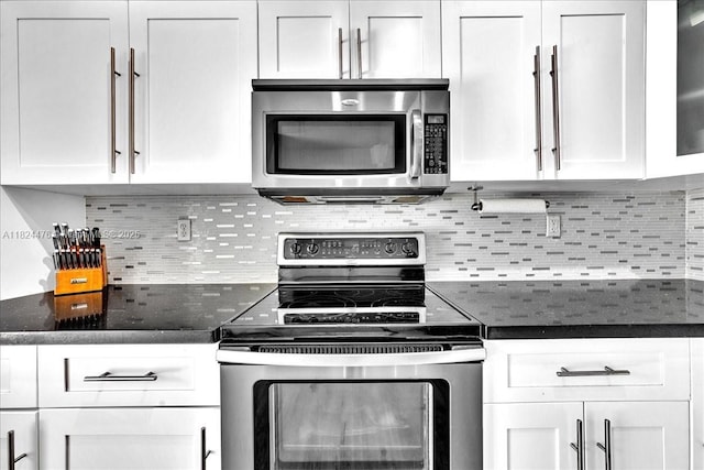 12926 SW 50th St, Miramar, FL 33027 - kitchen featuring appliances with stainless steel finishes, white cabinets, backsplash, and dark stone countertops