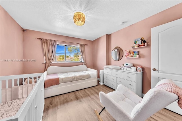 12926 SW 50th St, Miramar, FL 33027 - bedroom featuring light wood finished floors and a textured ceiling