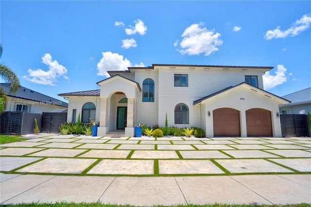 8965 NW 174th Ln, Hialeah, FL 33018 - view of front facade with a standing seam roof, an attached garage, concrete driveway, and a metal roof