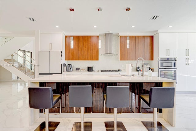 8965 NW 174th Ln, Hialeah, FL 33018 - kitchen with wall chimney range hood, modern cabinets, stainless steel oven, and recessed lighting