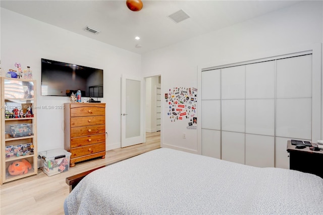 8965 NW 174th Ln, Hialeah, FL 33018 - bedroom featuring wood finished floors, white fridge, and a closet