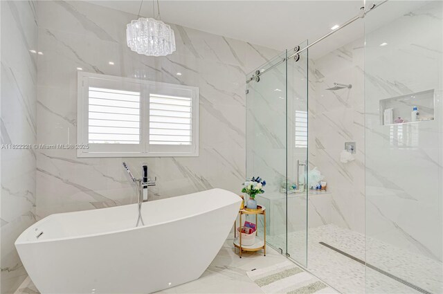 8965 NW 174th Ln, Hialeah, FL 33018 - full bath with a freestanding tub, a marble finish shower, marble tiled flooring, a chandelier, and tile walls